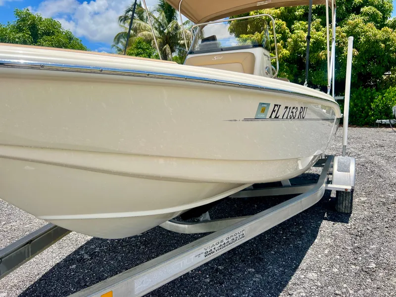 Slide: The Image of 2019 Scout Sportfish 175 boat on trailer, side view, sunny day. - 3