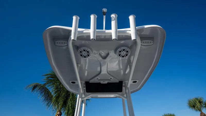 Slide: The Image of 2025 Tidewater 2210 Carolina Bay boat T-top with rod holders and speakers. - 11