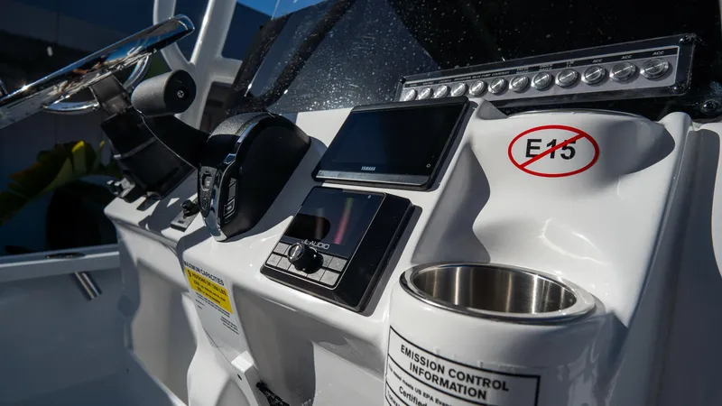 Slide: The Image of 2025 Tidewater 2210 Carolina Bay boat dashboard with controls and E15 fuel warning. - 14