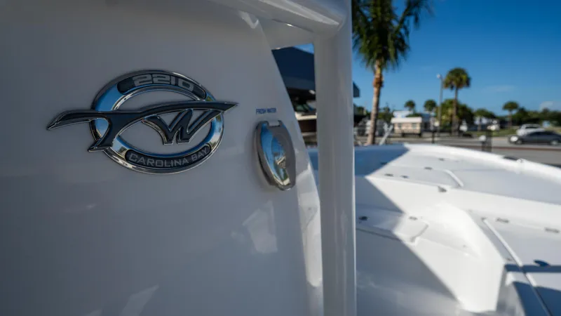 Slide: The Image of Close-up of 2025 Tidewater 2210 Carolina Bay boat emblem in a sunny marina. - 17