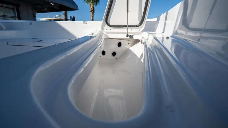 Slide: The Image of 2025 Tidewater 2210 Carolina Bay boat interior with open storage compartment. - 21