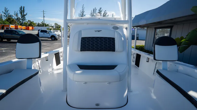 Slide: The Image of 2025 Tidewater 2210 Carolina Bay boat interior with white seating and console. - 27