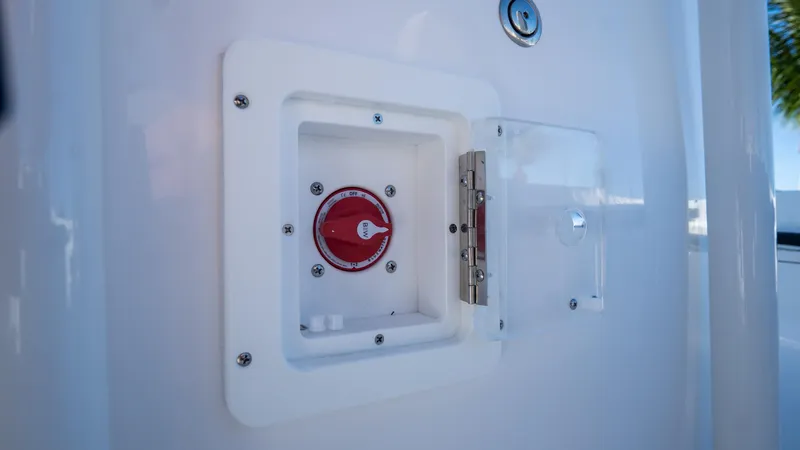 Slide: The Image of 2025 Tidewater 2210 Carolina Bay boat control panel with red dial and protective cover. - 28