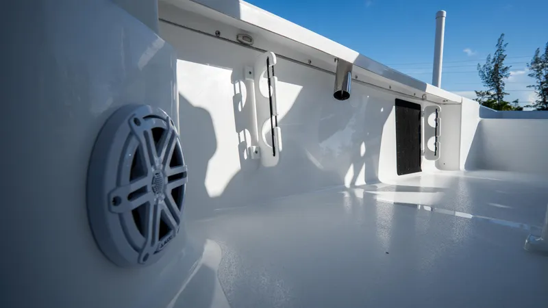 Slide: The Image of 2025 Tidewater 2210 Carolina Bay boat interior with speaker and rod holders. - 29