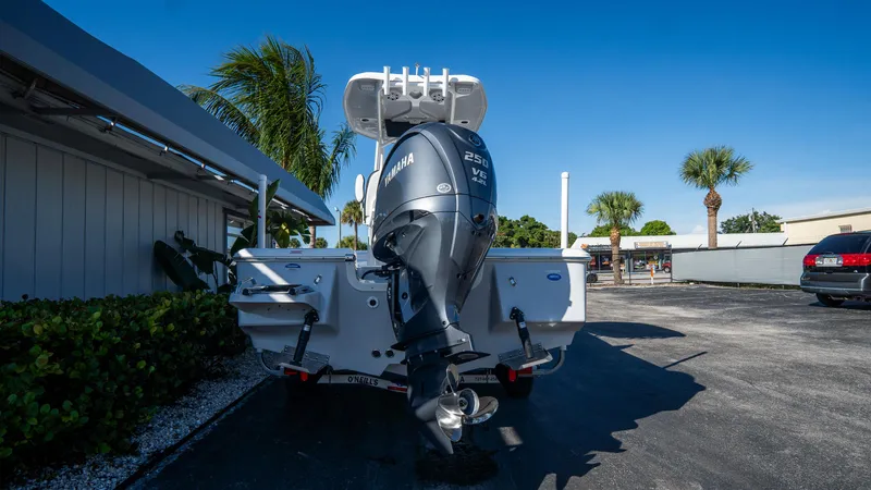 Slide: The Image of 2025 Tidewater 2210 Carolina Bay boat with Yamaha outboard motor in a sunny parking lot. - 4