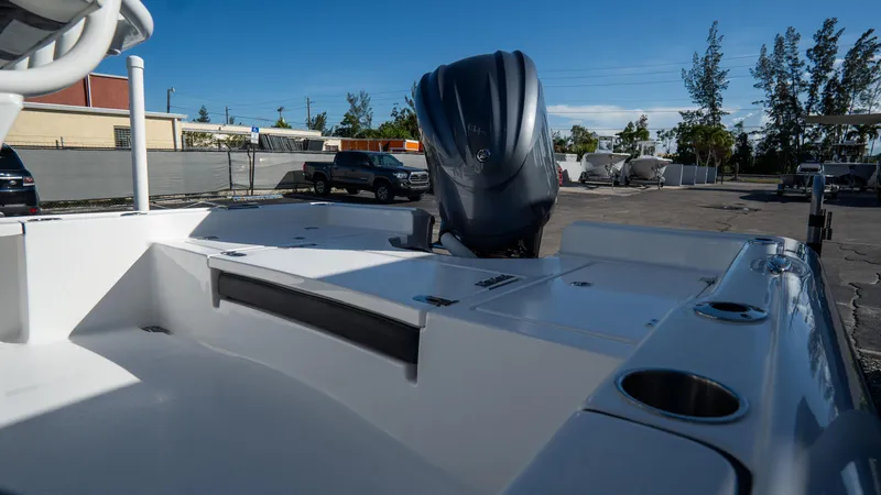 Slide: The Image of 2025 Tidewater 2210 Carolina Bay boat with outboard motor in a parking lot. - 5
