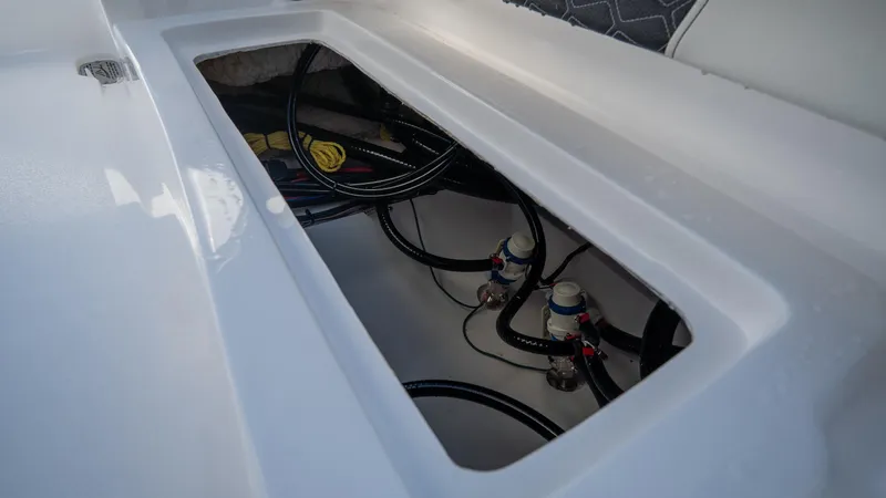 Slide: The Image of 2025 Tidewater 2210 Carolina Bay boat storage compartment with wiring and plumbing. - 8