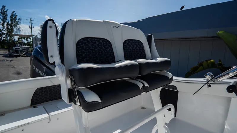 Slide: The Image of 2025 Tidewater 220 LXF boat with dual black and white cushioned seats. - 14