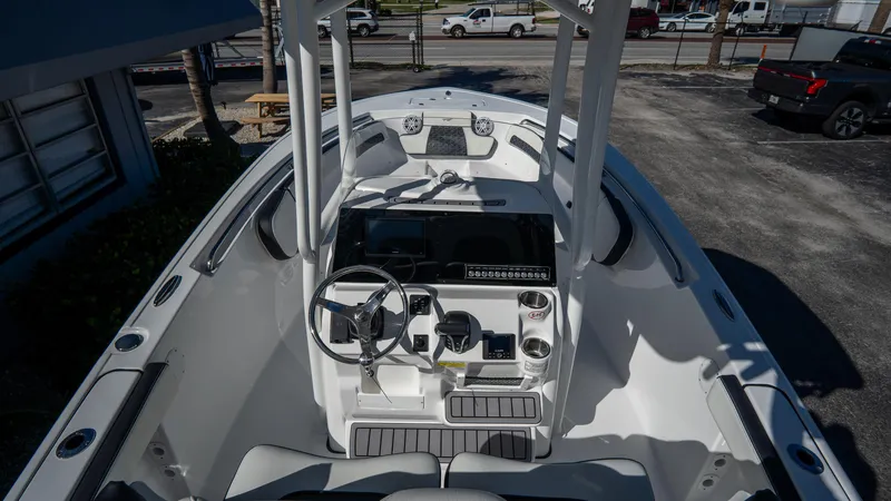 Slide: The Image of 2025 Tidewater 220 LXF boat cockpit with steering wheel and control panel. - 16