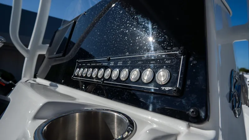 Slide: The Image of Control panel of the 2025 Tidewater 220 LXF boat with stainless steel cup holder. - 17