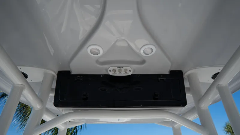 Slide: The Image of 2025 Tidewater 220 LXF boat T-top with integrated speakers and storage. - 19