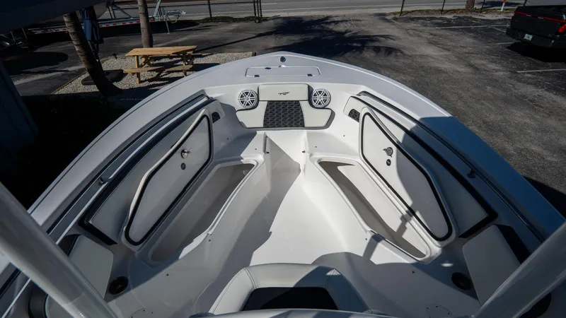 Slide: The Image of 2025 Tidewater 220 LXF boat interior, spacious bow seating and storage compartments. - 22