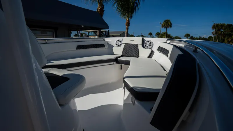 Slide: The Image of 2025 Tidewater 220 LXF boat interior with cushioned seating and speakers. - 26