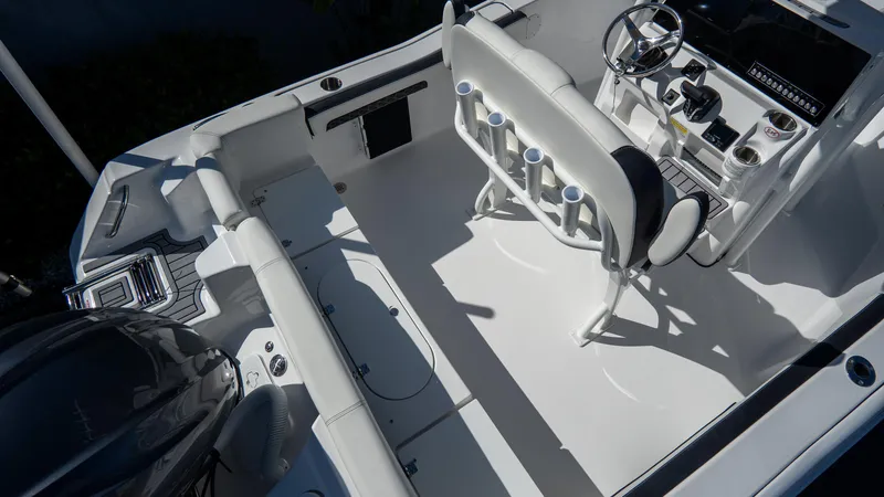 Slide: The Image of 2025 Tidewater 220 LXF boat interior with seating and steering console. - 5