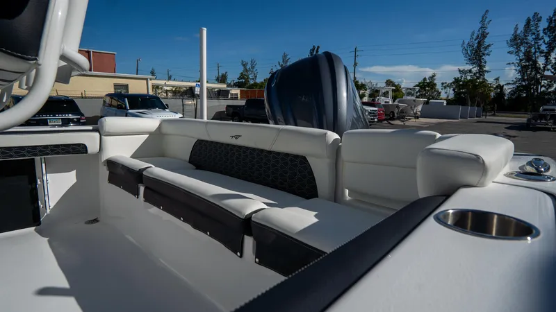 Slide: The Image of 2025 Tidewater 220 LXF boat interior with cushioned seating and cup holder. - 6