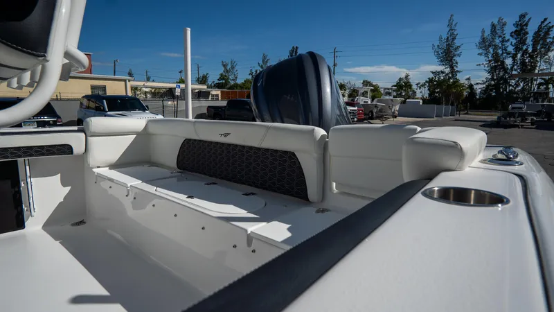 Slide: The Image of 2025 Tidewater 220 LXF boat interior with white seating and black accents. - 7