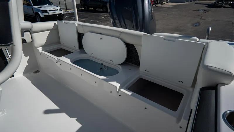 Slide: The Image of 2025 Tidewater 220 LXF boat interior with open storage compartments. - 9