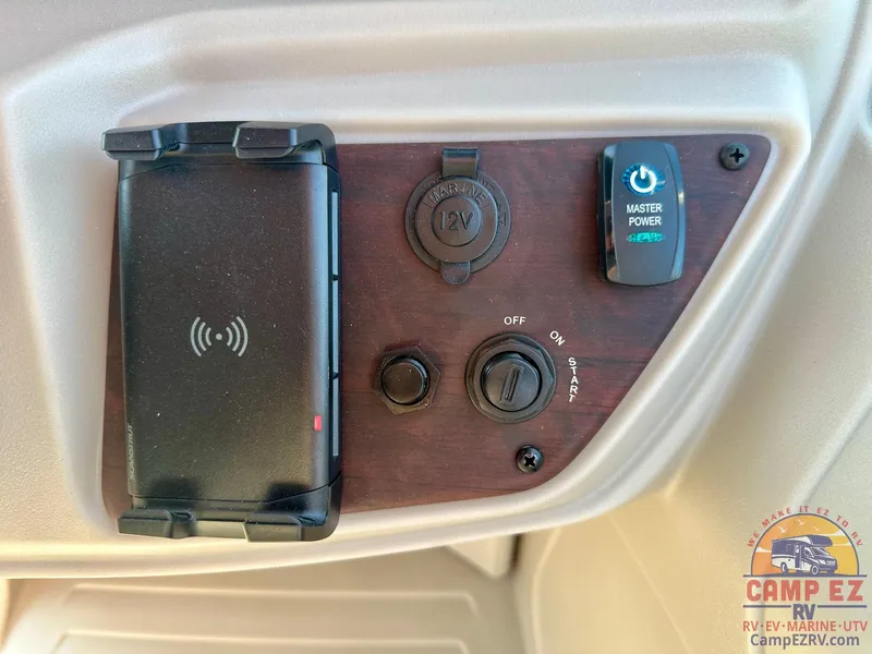 Slide: The Image of Control panel of 2025 South Bay 224FCR LE with power switches and phone holder. - 16