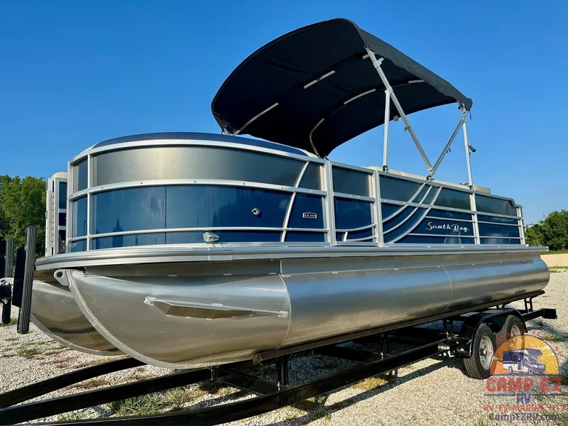 Slide: The Image of 2025 South Bay 224FCR LE pontoon boat with canopy on trailer. - 2