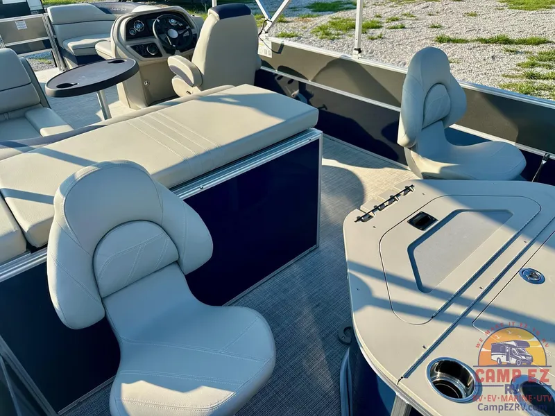 Slide: The Image of 2025 South Bay 224FCR LE pontoon boat interior with beige seating and steering console. - 23