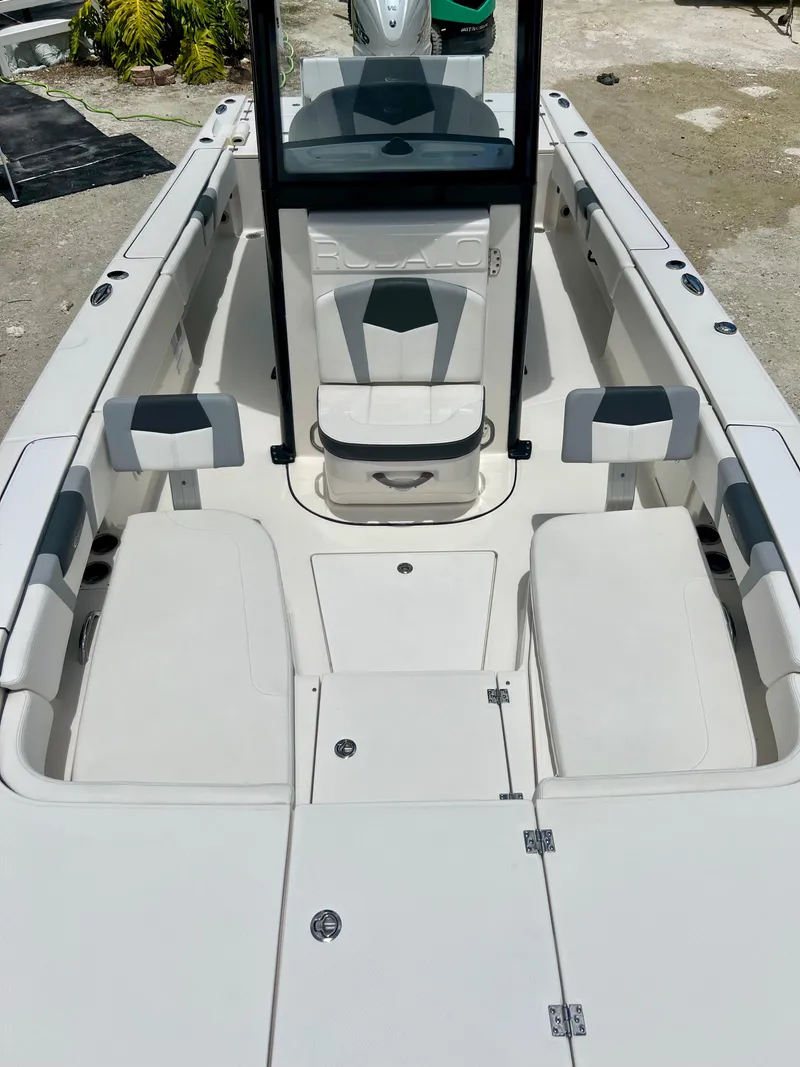 Slide: The Image of 2022 Robalo 266 Cayman boat interior with seating and storage compartments. - 13