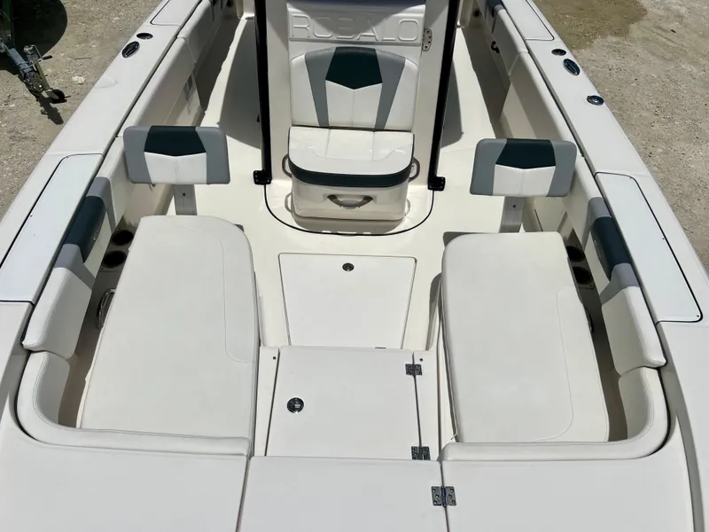 Slide: The Image of 2022 Robalo 266 Cayman boat interior with seating and storage compartments. - 14