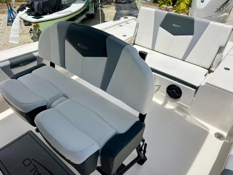 Slide: The Image of 2022 Robalo 266 Cayman boat interior seating with white and gray upholstery. - 19