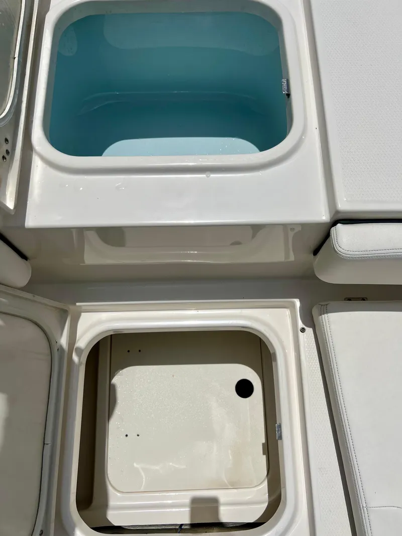 Slide: The Image of Livewell and storage compartments on a 2022 Robalo 266 Cayman boat. - 22
