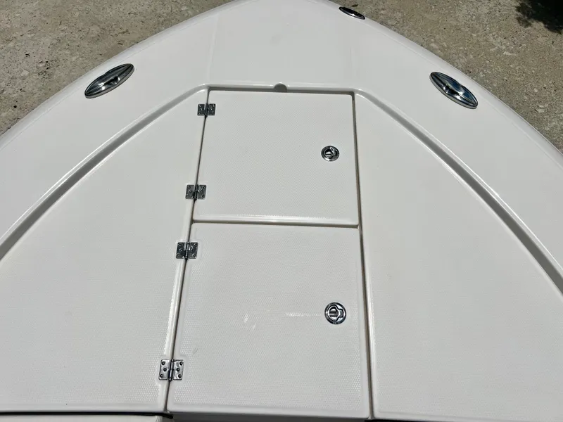 Slide: The Image of 2022 Robalo 266 Cayman bow storage compartments. - 23