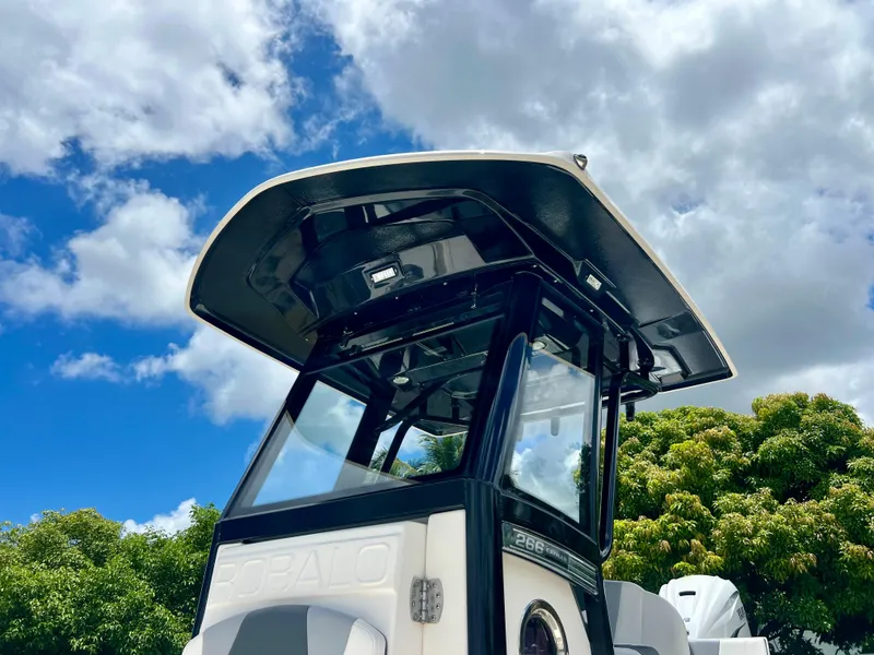 Slide: The Image of 2022 Robalo 266 Cayman boat with T-top against blue sky and clouds. - 27