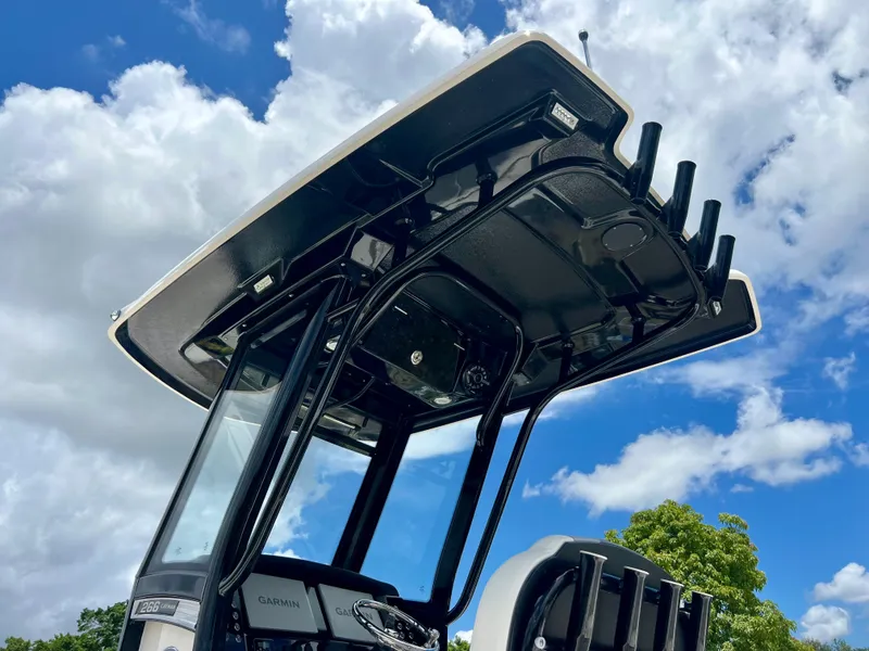 Slide: The Image of 2022 Robalo 266 Cayman T-top against a blue sky with clouds. - 28