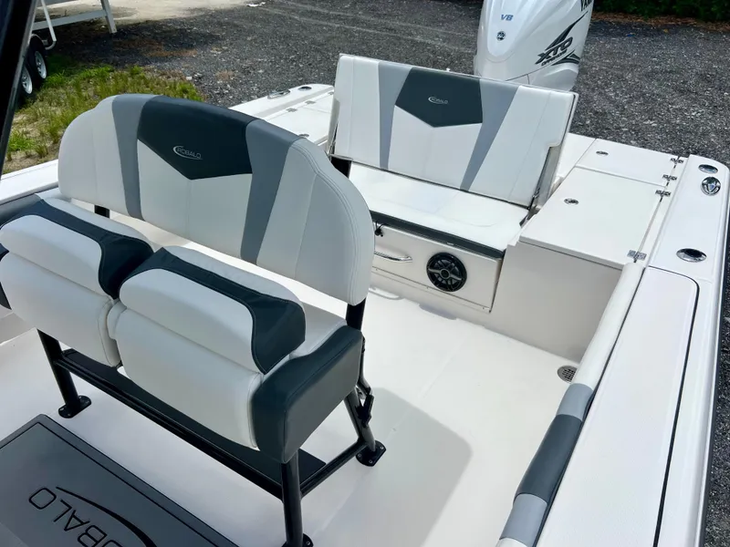 Slide: The Image of 2022 Robalo 266 Cayman boat interior with cushioned seating and storage compartments. - 29