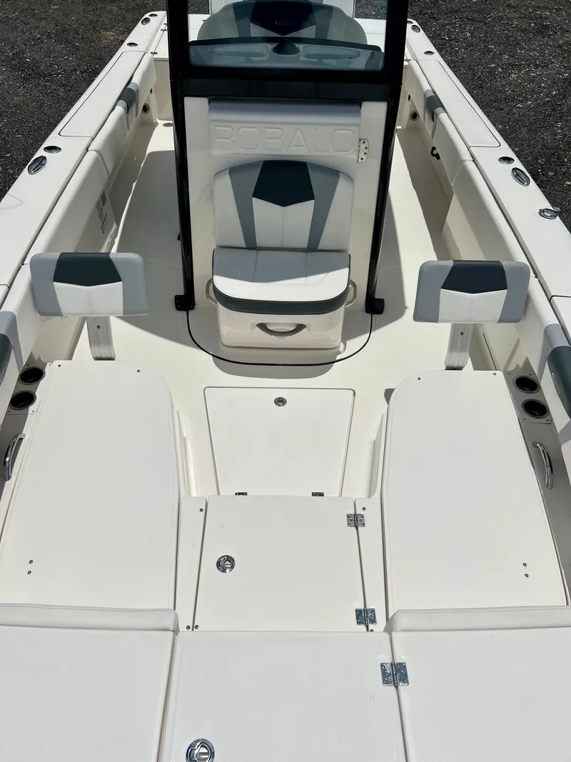 Slide: The Image of 2022 Robalo 266 Cayman boat interior with seating and storage compartments. - 33