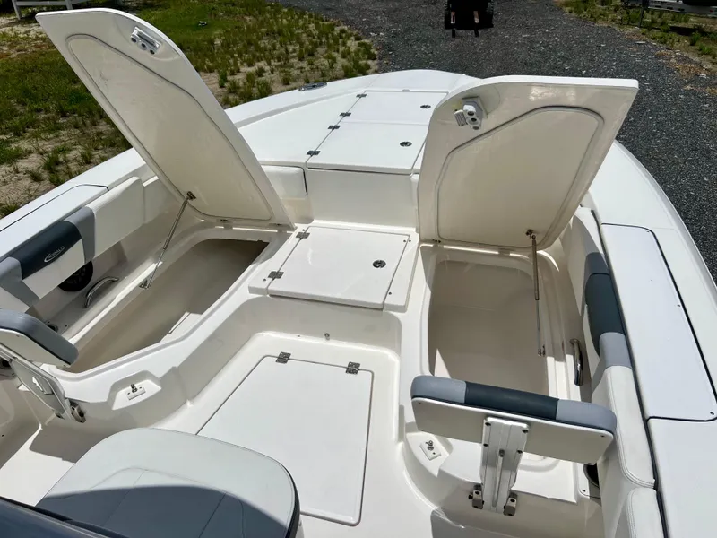 Slide: The Image of 2022 Robalo 266 Cayman boat with open storage compartments and seating. - 35