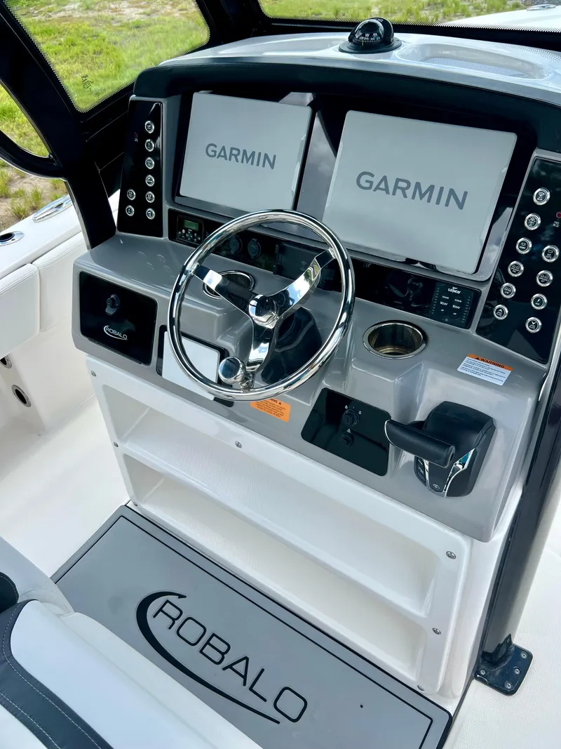 Slide: The Image of 2022 Robalo 266 Cayman boat dashboard with Garmin navigation systems. - 36