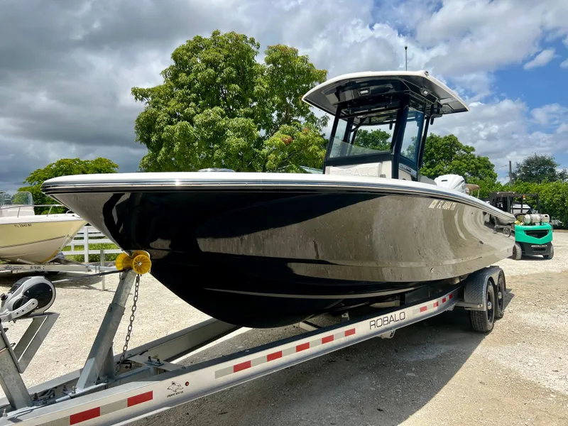 Slide: The Image of 2022 Robalo 266 Cayman boat on a trailer, ready for transport. - 6