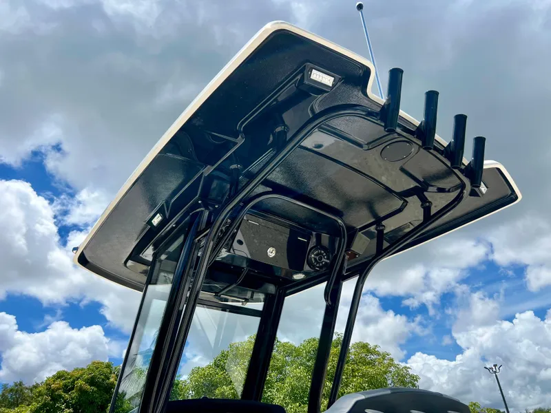 Slide: The Image of 2022 Robalo 266 Cayman T-top against a cloudy sky. - 9