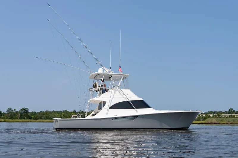 Slide: The Image of 2022 Viking 46 Billfish yacht on calm water under clear blue sky. - 10