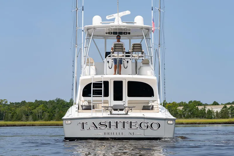Slide: The Image of 2022 Viking 46 Billfish yacht on water, rear view with "Tashtego" name. - 13