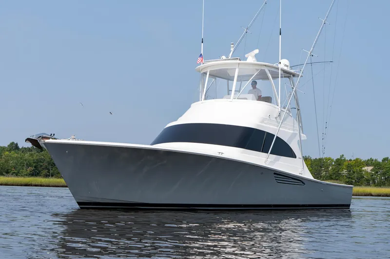 Slide: The Image of 2022 Viking 46 Billfish yacht on calm water, showcasing sleek design and fishing capabilities. - 23