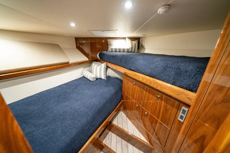 Slide: The Image of Luxurious cabin interior of 2022 Viking 46 Billfish yacht with wooden finishes and cozy bedding. - 24