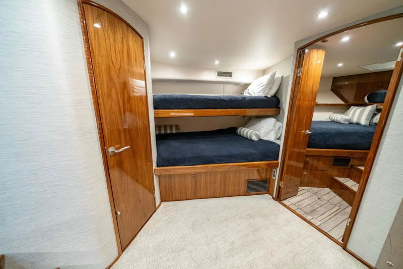 Slide: The Image of 2022 Viking 46 Billfish cabin with wooden bunk beds and modern lighting. - 26