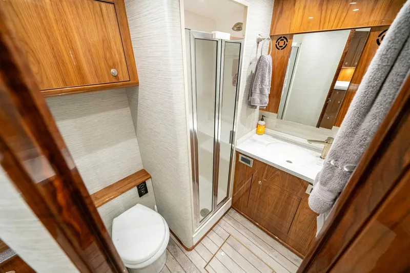 Slide: The Image of Luxurious bathroom in 2022 Viking 46 Billfish yacht with wood accents and modern fixtures. - 27