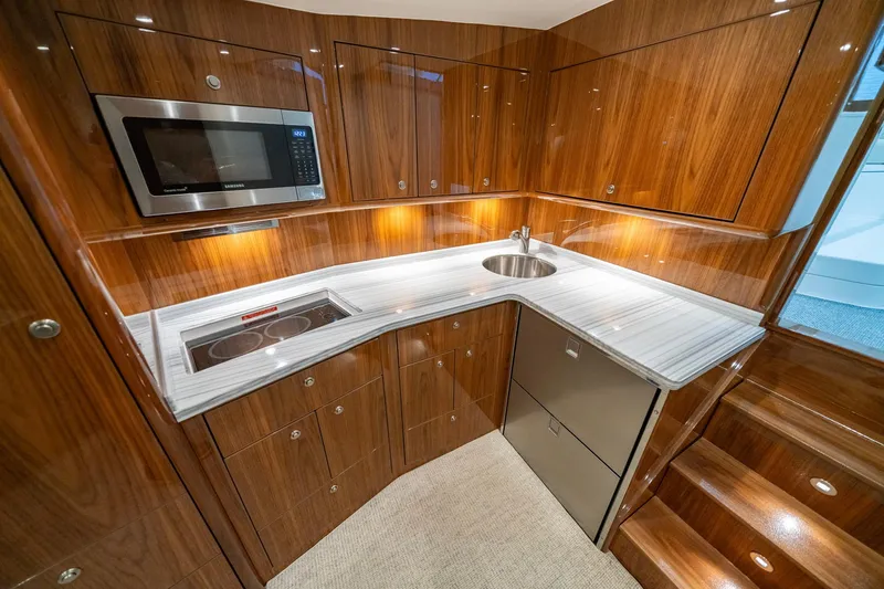 Slide: The Image of Luxurious kitchen in 2022 Viking 46 Billfish yacht with modern appliances and wood cabinetry. - 28