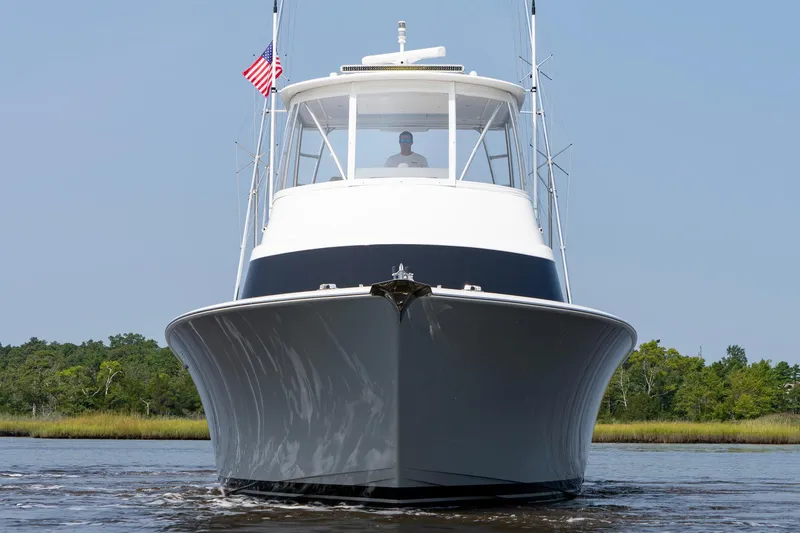 Slide: The Image of 2022 Viking 46 Billfish yacht on water, front view with American flag. - 3