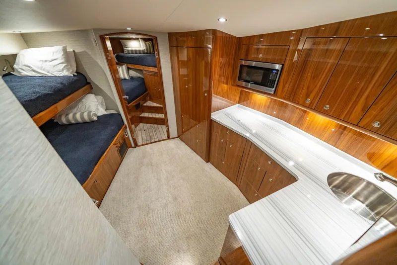 Slide: The Image of Luxurious interior of 2022 Viking 46 Billfish yacht with wood cabinetry and bunk beds. - 30