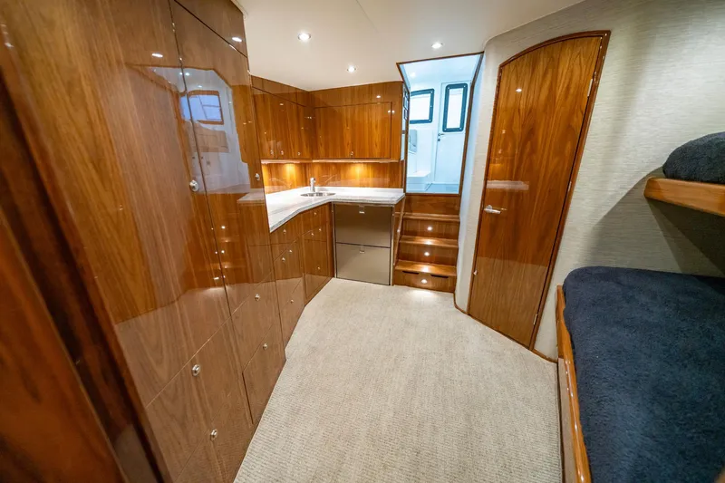 Slide: The Image of Luxurious interior of 2022 Viking 46 Billfish yacht with wood cabinetry and cozy seating. - 31