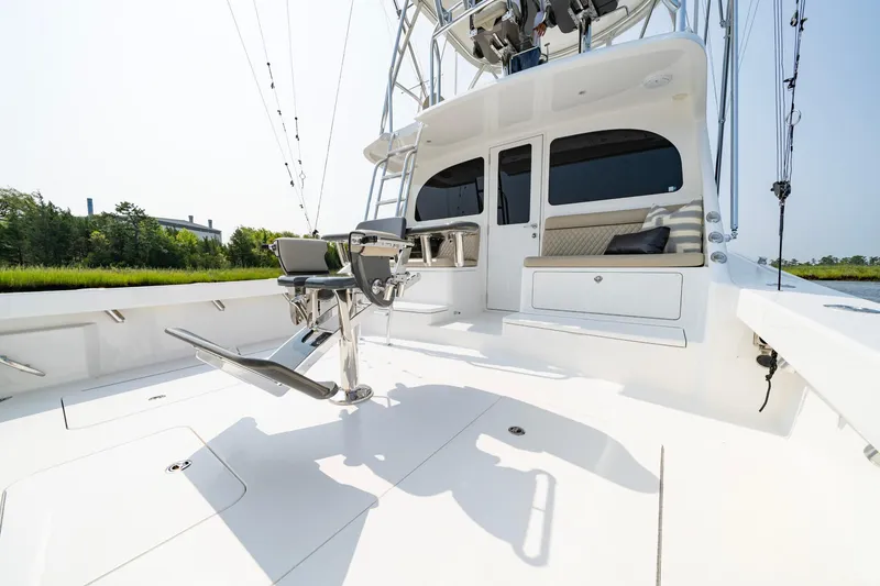 Slide: The Image of 2022 Viking 46 Billfish yacht deck with fishing chair and rod holders. - 34