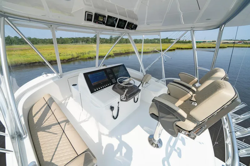 Slide: The Image of Luxurious 2022 Viking 46 Billfish yacht helm with plush seating and advanced navigation. - 38