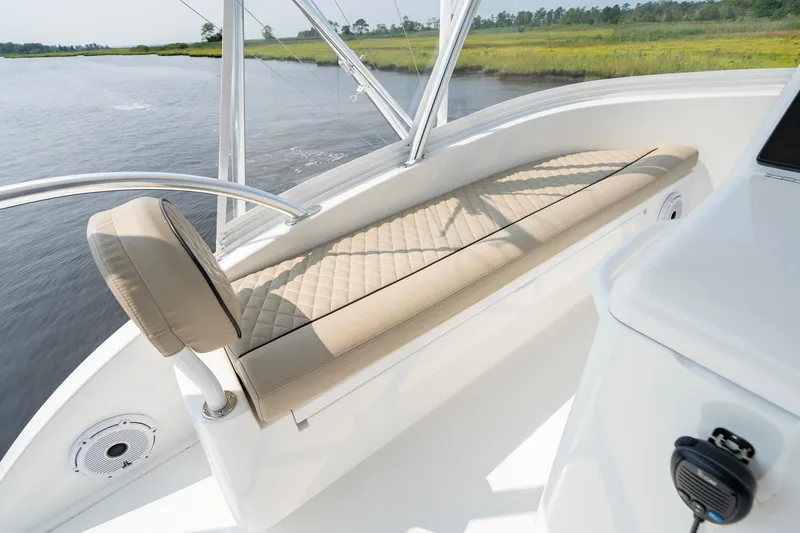 Slide: The Image of 2022 Viking 46 Billfish boat interior with cushioned seating and scenic water view. - 39